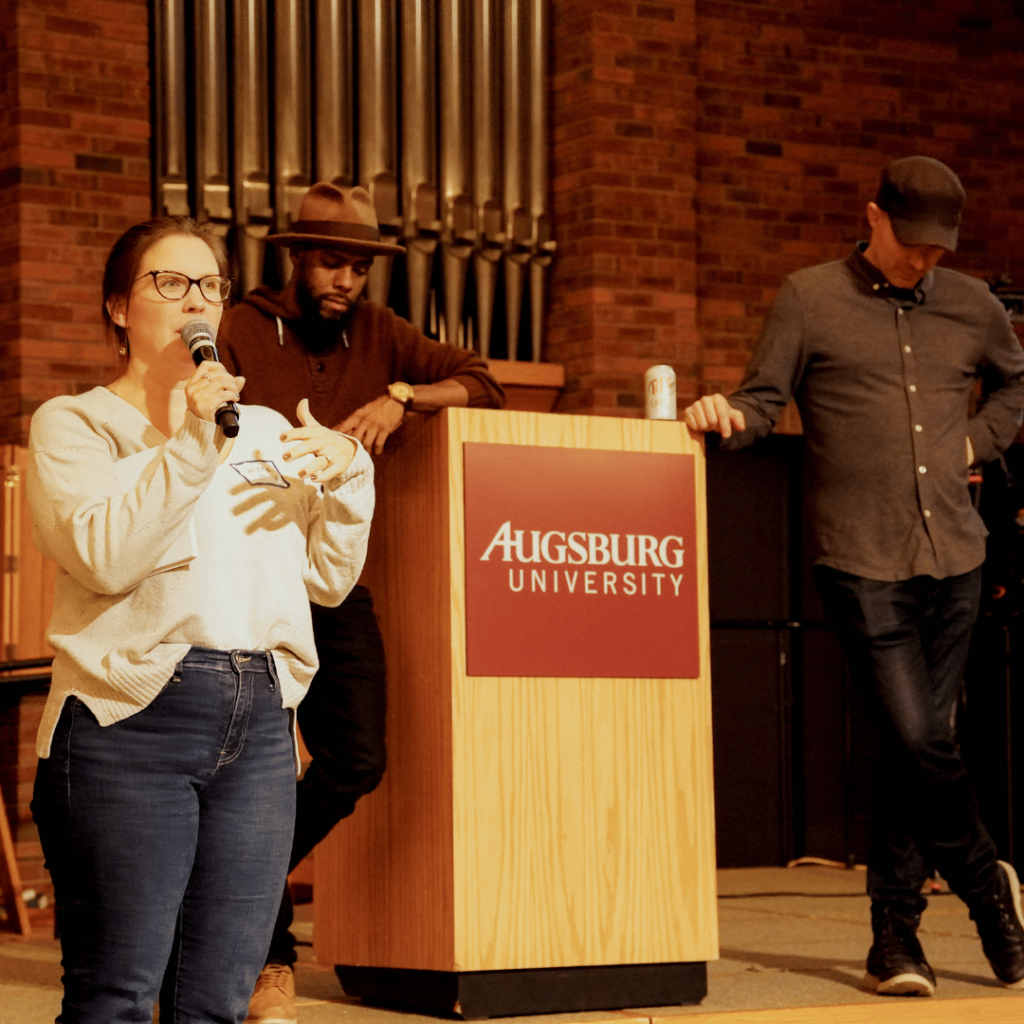 Kristina speaking to the whole group with Joe and Dave in the background